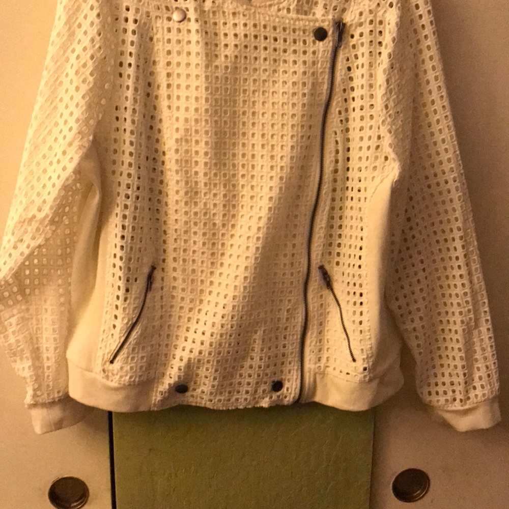 Off white zippered jacket with air holes.